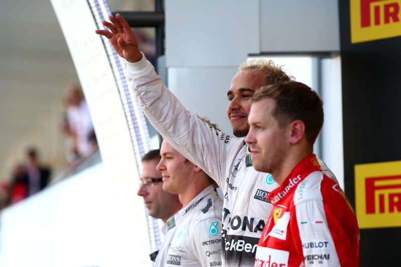 Lewis Hamilton of Great Britain and Mercedes GP celebrates on the podium next to Nico Rosberg of Germany and Mercedes GP and Sebastian Vettel of Germany and Ferrari after winning the Formula One Grand Prix of Japan at Suzuka Circuit on September 27, 2015 in Suzuka, Japan. Lewis Hamilton of Great Britain and Mercedes GP celebrates on the podium next to Nico Rosberg of Germany and Mercedes GP and Sebastian Vettel of Germany and Ferrari after winning the Formula One Grand Prix of Japan at Suzuka Circuit on September 27, 2015 in Suzuka, Japan.