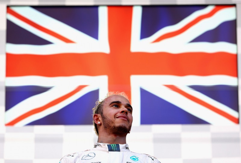 Lewis Hamilton of Great Britain and Mercedes GP celebrates with the trophy on the podium after winning the Formula One Grand Prix of Japan at Suzuka Circuit on September 27, 2015 in Suzuka, Japan. Lewis Hamilton of Great Britain and Mercedes GP celebrates with the trophy on the podium after winning the Formula One Grand Prix of Japan at Suzuka Circuit on September 27, 2015 in Suzuka, Japan.