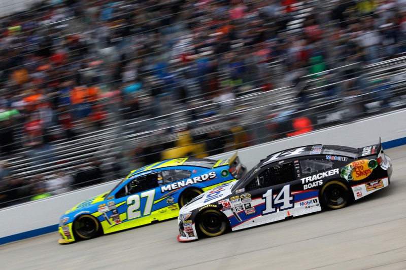 Paul Menard, driver of the #27 Knauf/Menards Chevrolet, races Tony Stewart, driver of the #14 Mobil 1/Bass Pro Shops Chevrolet, during the NASCAR Sprint Cup Series AAA 400 at Dover International Speedway on October 4, 2015 in Dover, Delaware. Paul Menard, driver of the #27 Knauf/Menards Chevrolet, races Tony Stewart, driver of the #14 Mobil 1/Bass Pro Shops Chevrolet, during the NASCAR Sprint Cup Series AAA 400 at Dover International Speedway on October 4, 2015 in Dover, Delaware.