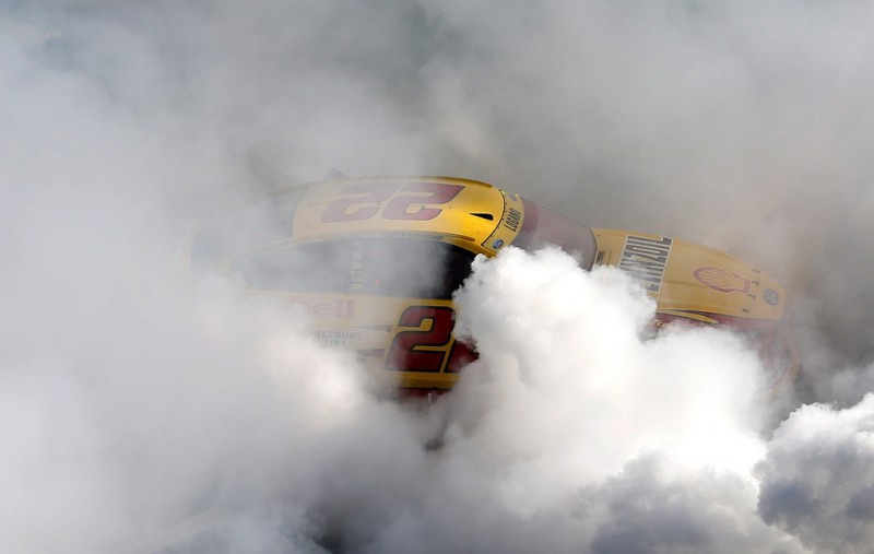 Joey Logano, driver of the #22 Shell Pennzoil Ford, celebrates with a burnout after winning the NASCAR Sprint Cup Series Bank of America 500 at Charlotte Motor Speedway on October 11, 2015 in Charlotte, North Carolina. Joey Logano, driver of the #22 Shell Pennzoil Ford, celebrates with a burnout after winning the NASCAR Sprint Cup Series Bank of America 500 at Charlotte Motor Speedway on October 11, 2015 in Charlotte, North Carolina.