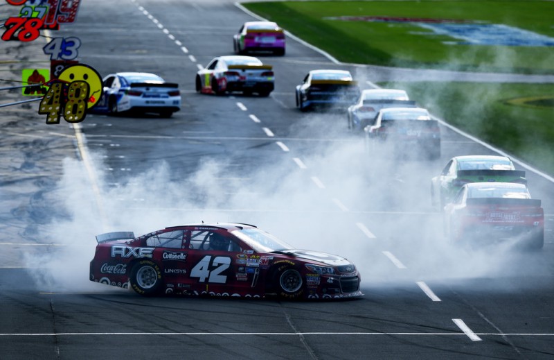 Kyle Larson, driver of the #42 Target Plaid Chevrolet, spins coming onto pit road during the NASCAR Sprint Cup Series Bank of America 500 at Charlotte Motor Speedway on October 11, 2015 in Charlotte, North Carolina. Kyle Larson, driver of the #42 Target Plaid Chevrolet, spins coming onto pit road during the NASCAR Sprint Cup Series Bank of America 500 at Charlotte Motor Speedway on October 11, 2015 in Charlotte, North Carolina.