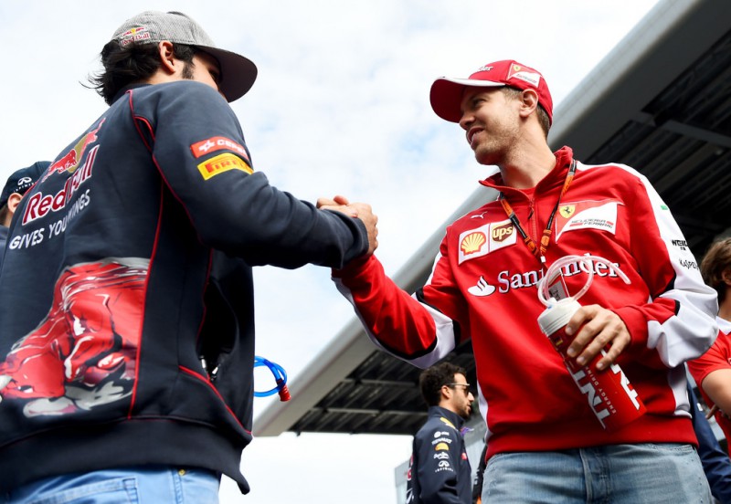 Carlos Sainz of Spain and Scuderia Toro Rosso speaks with Sebastian Vettel of Germany and Ferrari during the drivers' parade before the Formula One Grand Prix of Russia at Sochi Autodrom on October 11, 2015 in Sochi, Russia. Carlos Sainz of Spain and Scuderia Toro Rosso speaks with Sebastian Vettel of Germany and Ferrari during the drivers' parade before the Formula One Grand Prix of Russia at Sochi Autodrom on October 11, 2015 in Sochi, Russia.
