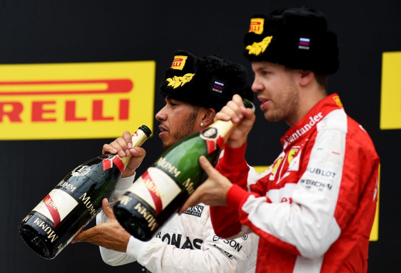1st placed Lewis Hamilton of Great Britain and Mercedes GP (c) celebrates with 2nd placed Sebastian Vettel of Germany and Ferrari after the Formula One Grand Prix of Russia at Sochi Autodrom on October 11, 2015 in Sochi, Russia. 1st placed Lewis Hamilton of Great Britain and Mercedes GP (c) celebrates with 2nd placed Sebastian Vettel of Germany and Ferrari after the Formula One Grand Prix of Russia at Sochi Autodrom on October 11, 2015 in Sochi, Russia.