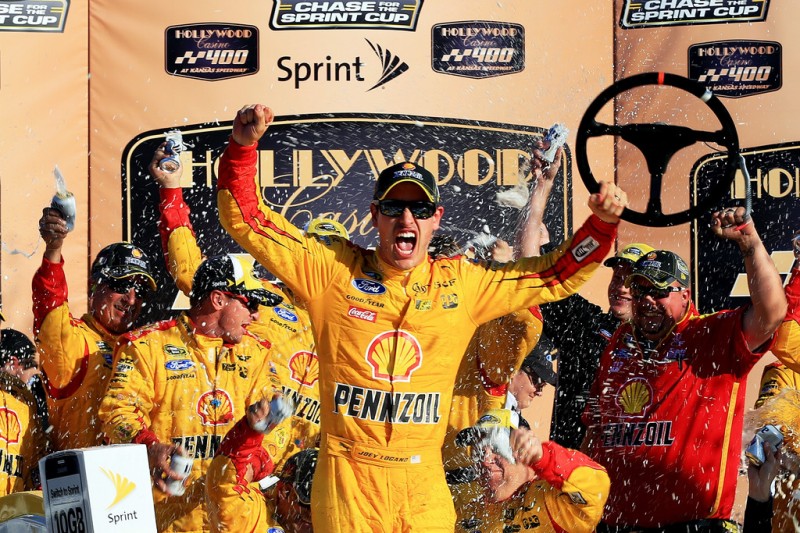 Joey Logano, driver of the #22 Shell Pennzoil Ford, celebrates in Victory Lane after winning the NASCAR Sprint Cup Series Hollywood Casino 400 at Kansas Speedway on October 18, 2015 in Kansas City, Kansas. Joey Logano, driver of the #22 Shell Pennzoil Ford, celebrates in Victory Lane after winning the NASCAR Sprint Cup Series Hollywood Casino 400 at Kansas Speedway on October 18, 2015 in Kansas City, Kansas.