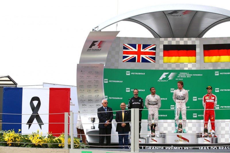 Nico Rosberg of Germany and Mercedes GP, Lewis Hamilton of Great Britain and Mercedes GP and Sebastian Vettel of Germany and Ferrari stand on the podium next to a french national flag in tribute to the victims of the recent terrorist attacks in Paris after the Formula One Grand Prix of Brazil at Autodromo Jose Carlos Pace on November 15, 2015 in Sao Paulo, Brazil. Nico Rosberg of Germany and Mercedes GP, Lewis Hamilton of Great Britain and Mercedes GP and Sebastian Vettel of Germany and Ferrari stand on the podium next to a french national flag in tribute to the victims of the recent terrorist attacks in Paris after the Formula One Grand Prix of Brazil at Autodromo Jose Carlos Pace on November 15, 2015 in Sao Paulo, Brazil.