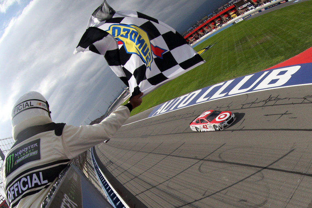 Kyle Larson, driver of the #42 Target Chevrolet, takes the checkered flag to win the Monster Energy NASCAR Cup Series Auto Club 400 at Auto Club Speedway on March 26, 2017 in Fontana, California.