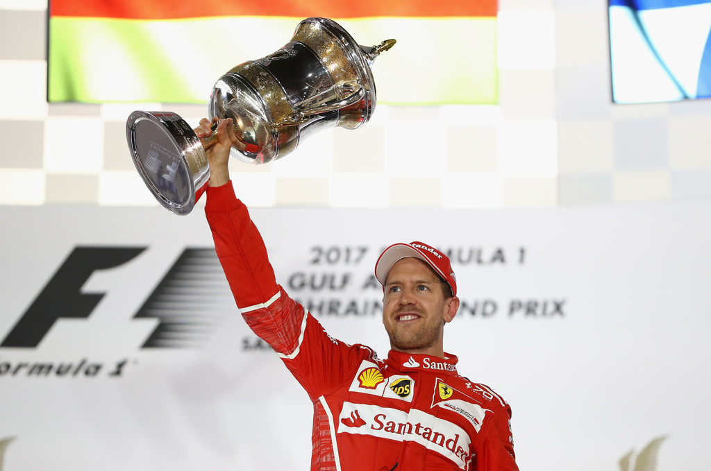 Race winner Sebastian Vettel of Germany and Ferrari celebrates his win on the podium during the Bahrain Formula One Grand Prix at Bahrain International Circuit on April 16, 2017 in Bahrain, Bahrain. Race winner Sebastian Vettel of Germany and Ferrari celebrates his win on the podium during the Bahrain Formula One Grand Prix at Bahrain International Circuit on April 16, 2017 in Bahrain, Bahrain.