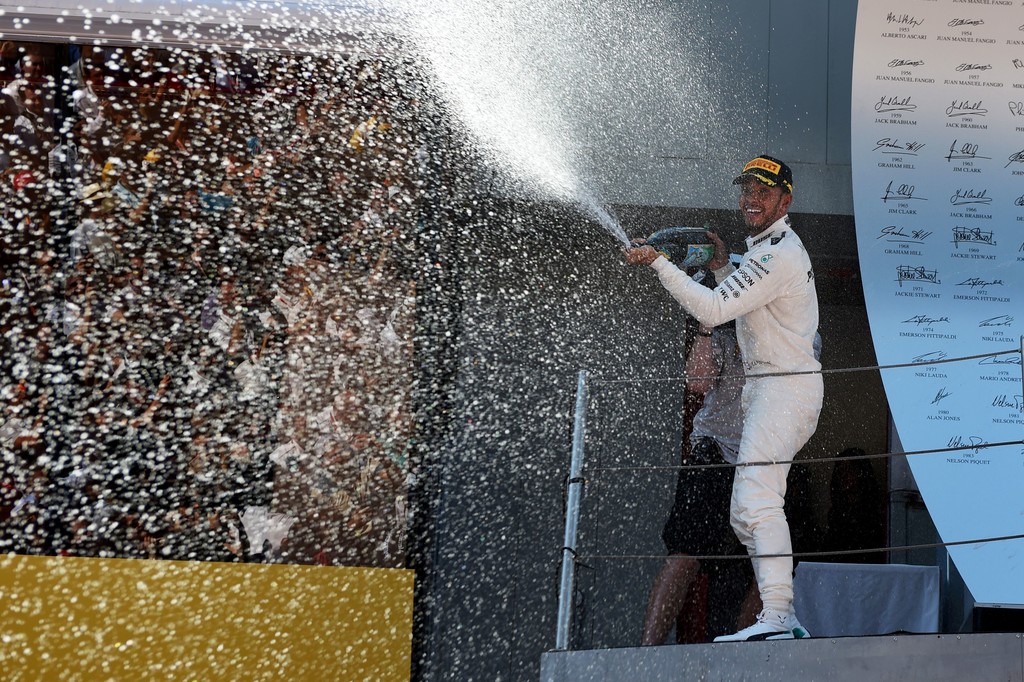 Mercedes' British driver Lewis Hamilton sprays Cava as he celebrates on the podium after winning the Spanish Formula One Grand Prix on May 14, 2017 at the Circuit de Catalunya in Montmelo on the outskirts of Barcelona. Mercedes' British driver Lewis Hamilton sprays Cava as he celebrates on the podium after winning the Spanish Formula One Grand Prix on May 14, 2017 at the Circuit de Catalunya in Montmelo on the outskirts of Barcelona.