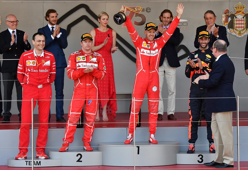 Winner Ferrari's German driver Sebastian Vettel (C) celebrates on the podium next to second placed Ferrari's Finnish driver Kimi Raikkonen (L) and third placed Red Bull's Australian driver Daniel Ricciardo (R) after the Monaco Formula 1 Grand Prix at the Monaco street circuit, on May 28, 2017 in Monaco. Winner Ferrari's German driver Sebastian Vettel (C) celebrates on the podium next to second placed Ferrari's Finnish driver Kimi Raikkonen (L) and third placed Red Bull's Australian driver Daniel Ricciardo (R) after the Monaco Formula 1 Grand Prix at the Monaco street circuit, on May 28, 2017 in Monaco.