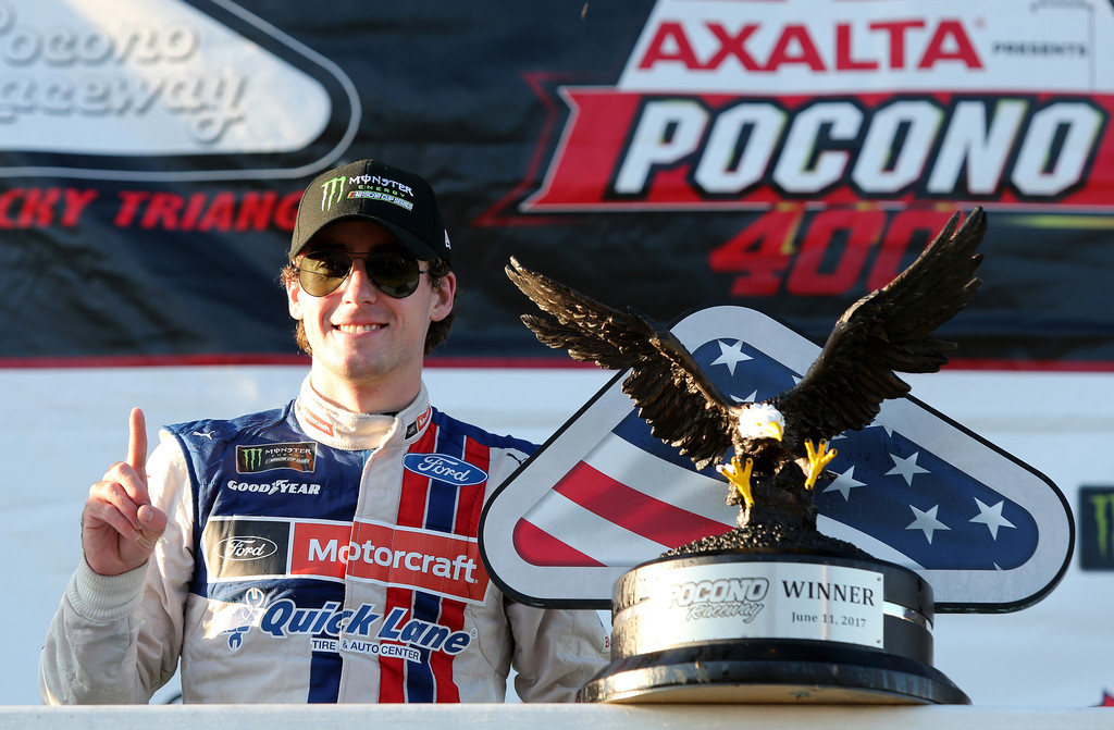 Ryan Blaney, driver of the #21 Motorcraft/Quick Lane Tire & Auto Center Ford, poses with the trophy in Victory Lane after winning the Monster Energy NASCAR Cup Series Axalta presents the Pocono 400 at Pocono Raceway on June 11, 2017 in Long Pond, Pennsylvania. Ryan Blaney, driver of the #21 Motorcraft/Quick Lane Tire & Auto Center Ford, poses with the trophy in Victory Lane after winning the Monster Energy NASCAR Cup Series Axalta presents the Pocono 400 at Pocono Raceway on June 11, 2017 in Long Pond, Pennsylvania.