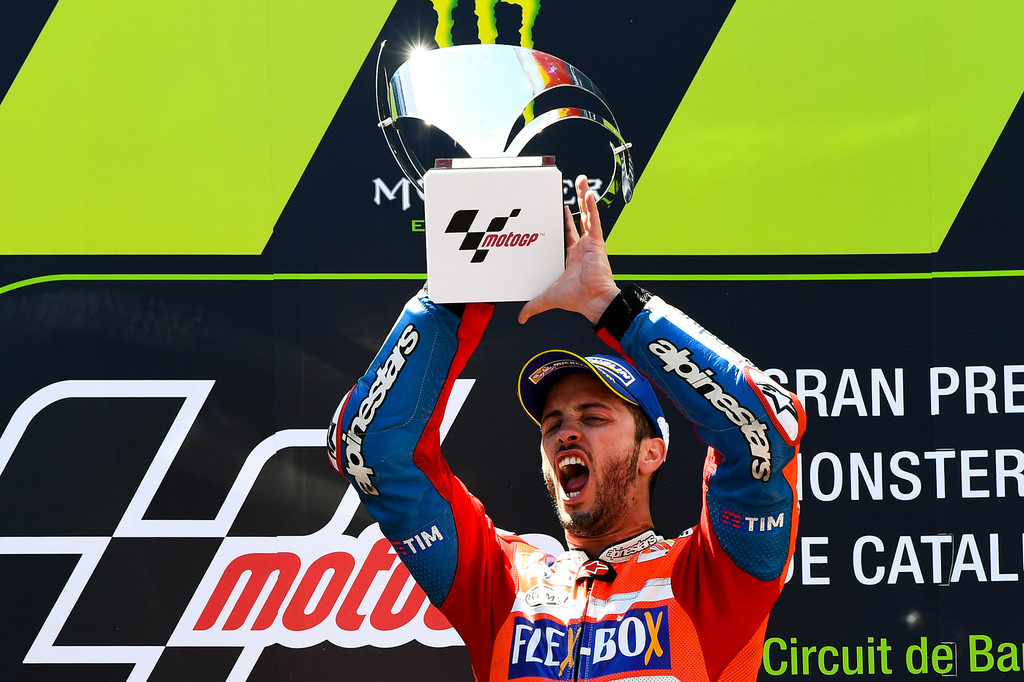 Andrea Dovizioso of Italy and Ducati Team celebrates on the podium after winning the MotoGp of Catalunya at Circuit de Catalunya on June 11, 2017 in Montmelo, Spain. Andrea Dovizioso of Italy and Ducati Team celebrates on the podium after winning the MotoGp of Catalunya at Circuit de Catalunya on June 11, 2017 in Montmelo, Spain.
