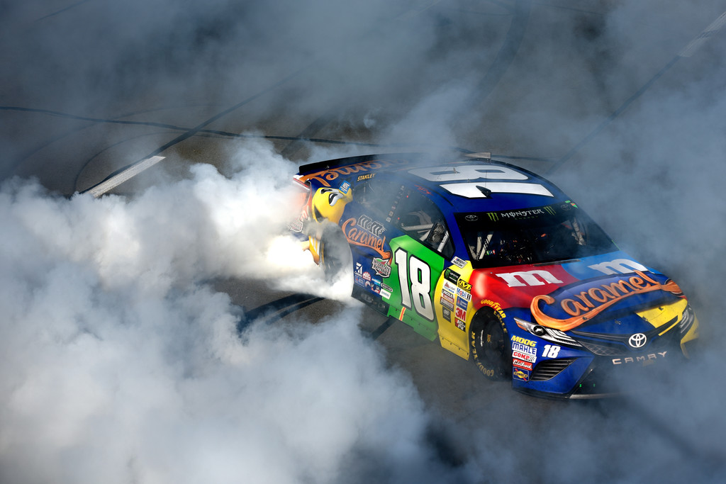Kyle Busch, driver of the #18 M&M's Caramel Toyota, celebrates with a burnout after winning the Monster Energy NASCAR Cup Series Overton's 400 at Pocono Raceway on July 30, 2017 in Long Pond, Pennsylvania. Kyle Busch, driver of the #18 M&M's Caramel Toyota, celebrates with a burnout after winning the Monster Energy NASCAR Cup Series Overton's 400 at Pocono Raceway on July 30, 2017 in Long Pond, Pennsylvania.