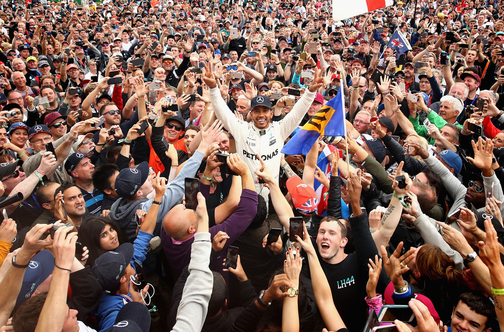 Race winner Lewis Hamilton of Great Britain and Mercedes GP celebrates with the fans after the Formula One Grand Prix of Great Britain at Silverstone on July 16, 2017 in Northampton, England. Race winner Lewis Hamilton of Great Britain and Mercedes GP celebrates with the fans after the Formula One Grand Prix of Great Britain at Silverstone on July 16, 2017 in Northampton, England.