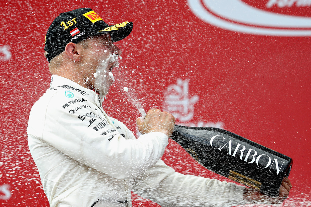 Race winner Valtteri Bottas of Finland and Mercedes GP celebrates his win on the podium during the Formula One Grand Prix of Austria at Red Bull Ring on July 9, 2017 in Spielberg, Austria. Race winner Valtteri Bottas of Finland and Mercedes GP celebrates his win on the podium during the Formula One Grand Prix of Austria at Red Bull Ring on July 9, 2017 in Spielberg, Austria.
