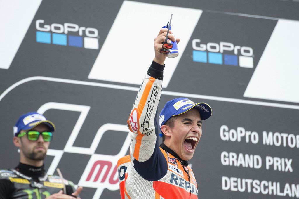 Marc Marquez of Spain and Repsol Honda Team celebrates the victory on the podium at the end of the MotoGP race during the MotoGp of Germany - Race at Sachsenring Circuit on July 2, 2017 in Hohenstein-Ernstthal, Germany. Marc Marquez of Spain and Repsol Honda Team celebrates the victory on the podium at the end of the MotoGP race during the MotoGp of Germany - Race at Sachsenring Circuit on July 2, 2017 in Hohenstein-Ernstthal, Germany.