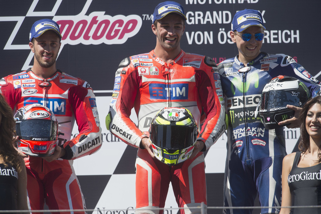 Andrea Dovizioso of Italy and Ducati Team, Andrea Iannone of Italy and Ducati Team and Jorge Lorenzo of Spain and Movistar Yamaha MotoGP celebrate on the podium at the end of the MotoGp race during the MotoGp of Austria - Race at Red Bull Ring on August 14, 2016 in Spielberg, Austria. Andrea Dovizioso of Italy and Ducati Team, Andrea Iannone of Italy and Ducati Team and Jorge Lorenzo of Spain and Movistar Yamaha MotoGP celebrate on the podium at the end of the MotoGp race during the MotoGp of Austria - Race at Red Bull Ring on August 14, 2016 in Spielberg, Austria.