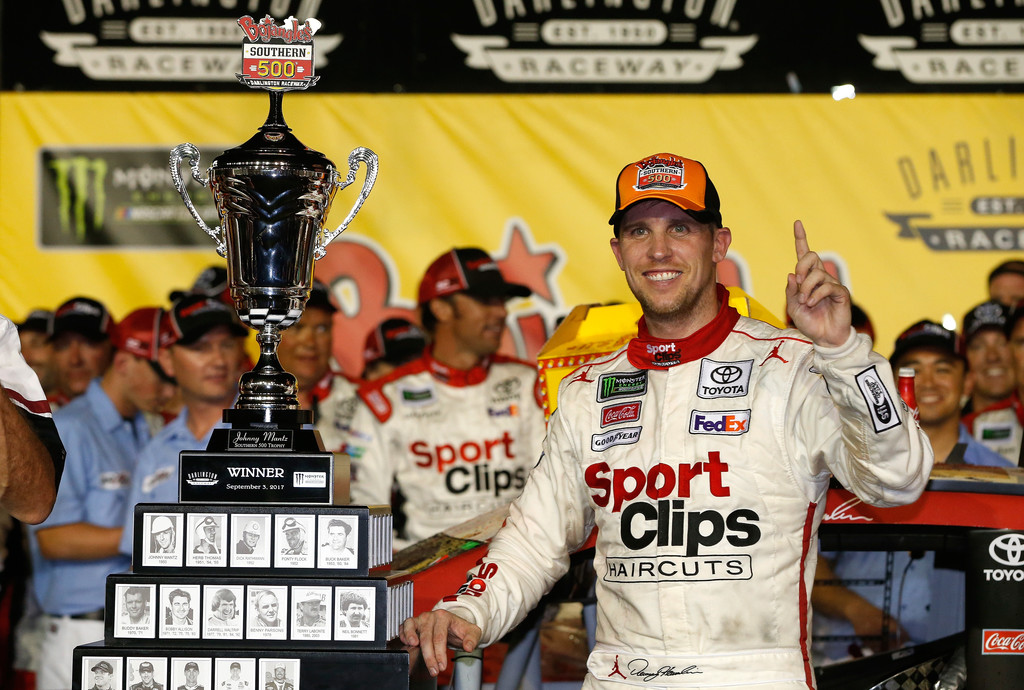 Denny Hamlin, driver of the #11 Sport Clips Toyota, poses with the trophy in Victory Lane after winning the Monster Energy NASCAR Cup Series Bojangles' Southern 500 at Darlington Raceway on September 3, 2017 in Darlington, South Carolina. Denny Hamlin, driver of the #11 Sport Clips Toyota, poses with the trophy in Victory Lane after winning the Monster Energy NASCAR Cup Series Bojangles' Southern 500 at Darlington Raceway on September 3, 2017 in Darlington, South Carolina.