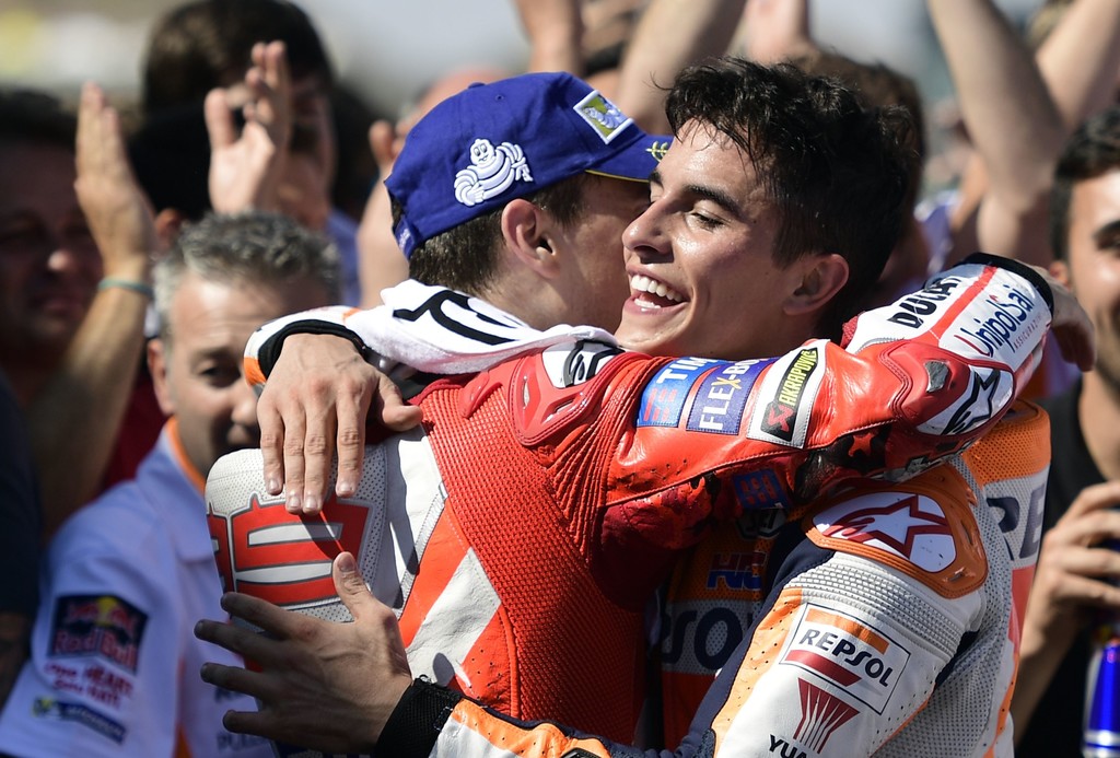 Repsol Honda Team's Spanish rider Marc Marquez (R) celebrates with Ducati Team's Spanish rider Jorge Lorenzo after winning the MotoGP race of the Moto Grand Prix of Aragon at the Motorland circuit in Alcaniz on September 24, 2017. Repsol Honda Team's Spanish rider Marc Marquez (R) celebrates with Ducati Team's Spanish rider Jorge Lorenzo after winning the MotoGP race of the Moto Grand Prix of Aragon at the Motorland circuit in Alcaniz on September 24, 2017.