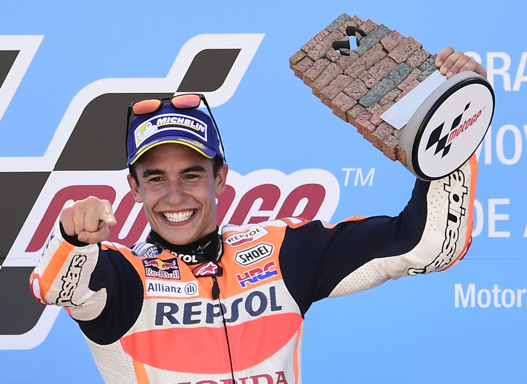 Repsol Honda Team's Spanish rider Marc Marquez celebrates on the podium winning the MOTO GP race of the Moto Grand Prix of Aragon at the Motorland circuit in Alcaniz on September 24, 2017. Repsol Honda Team's Spanish rider Marc Marquez celebrates on the podium winning the MOTO GP race of the Moto Grand Prix of Aragon at the Motorland circuit in Alcaniz on September 24, 2017.