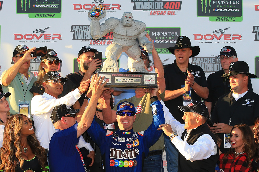 Kyle Busch, driver of the #18 M&M's Caramel Toyota, lifts the trophy after winning the Monster Energy NASCAR Cup Series Apache Warrior 400 presented by Lucas Oil at Dover International Speedway on October 1, 2017 in Dover, Delaware. Kyle Busch, driver of the #18 M&M's Caramel Toyota, lifts the trophy after winning the Monster Energy NASCAR Cup Series Apache Warrior 400 presented by Lucas Oil at Dover International Speedway on October 1, 2017 in Dover, Delaware.