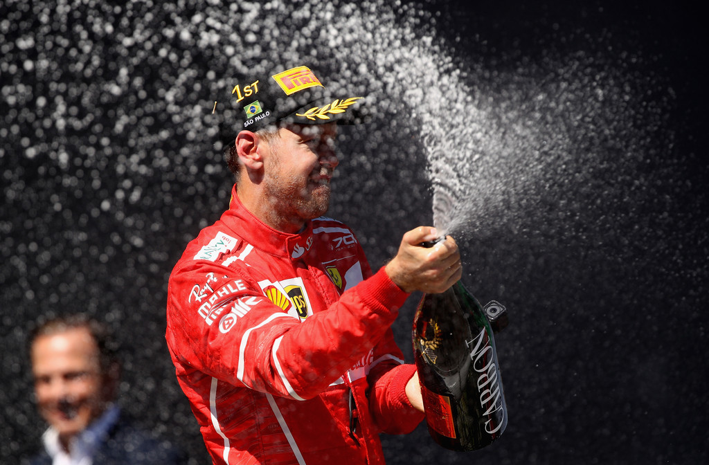 Race winner Sebastian Vettel of Germany and Ferrari celebrates on the podium during the Formula One Grand Prix of Brazil at Autodromo Jose Carlos Pace on November 12, 2017 in Sao Paulo, Brazil. Race winner Sebastian Vettel of Germany and Ferrari celebrates on the podium during the Formula One Grand Prix of Brazil at Autodromo Jose Carlos Pace on November 12, 2017 in Sao Paulo, Brazil.
