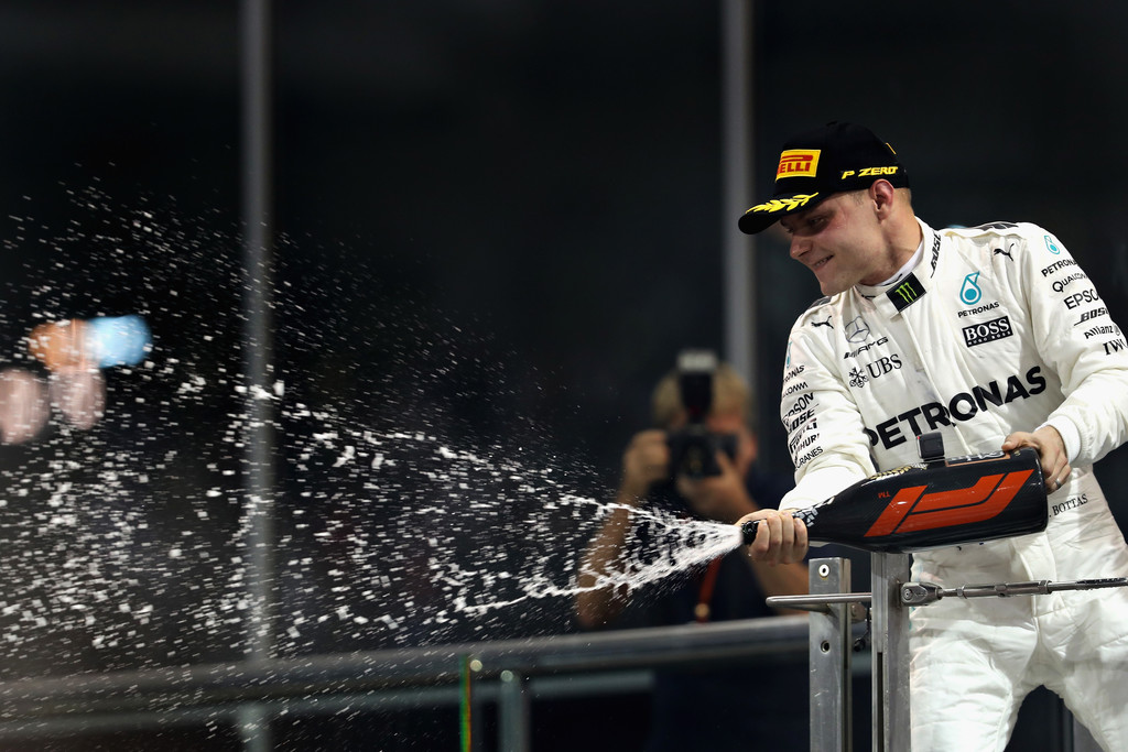 Race winner Valtteri Bottas of Finland and Mercedes GP celebrates on the podium during the Abu Dhabi Formula One Grand Prix at Yas Marina Circuit on November 26, 2017 in Abu Dhabi, United Arab Emirates. Race winner Valtteri Bottas of Finland and Mercedes GP celebrates on the podium during the Abu Dhabi Formula One Grand Prix at Yas Marina Circuit on November 26, 2017 in Abu Dhabi, United Arab Emirates.