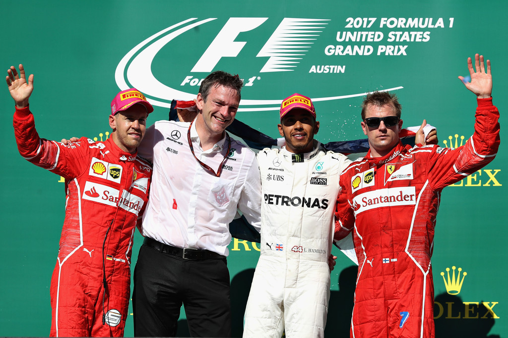 Top three finishers Lewis Hamilton of Great Britain and Mercedes GP, Sebastian Vettel of Germany and Ferrari, Kimi Raikkonen of Finland and Ferrari and James Allison, Technical Director at Mercedes GP celebrate on the podium during the United States Formula One Grand Prix at Circuit of The Americas on October 22, 2017 in Austin, Texas. Top three finishers Lewis Hamilton of Great Britain and Mercedes GP, Sebastian Vettel of Germany and Ferrari, Kimi Raikkonen of Finland and Ferrari and James Allison, Technical Director at Mercedes GP celebrate on the podium during the United States Formula One Grand Prix at Circuit of The Americas on October 22, 2017 in Austin, Texas.