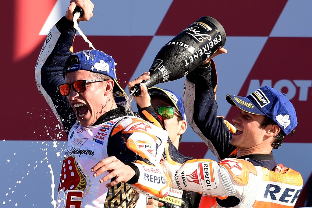 Repsol Honda Team's Spanish rider Dani Pedrosa (R) and Monster Yamaha Tech 3's French rider Johann Zarco spray cava on Repsol Honda Team's Spanish rider Marc Marquez (L) on the podium of the MotoGP race of the Valencia Grand Prix at Ricardo Tormo racetrack in Cheste, near Valencia on November 12, 2017. .Spain's Marc Marquez sealed his sixth world championship and fourth in the premier MotoGP category with third place at the Valencia Grand Prix. Marquez's Honda teammate Dani Pedrosa won the race from France's Johann Zarco in second. Repsol Honda Team's Spanish rider Dani Pedrosa (R) and Monster Yamaha Tech 3's French rider Johann Zarco spray cava on Repsol Honda Team's Spanish rider Marc Marquez (L) on the podium of the MotoGP race of the Valencia Grand Prix at Ricardo Tormo racetrack in Cheste, near Valencia on November 12, 2017. .Spain's Marc Marquez sealed his sixth world championship and fourth in the premier MotoGP category with third place at the Valencia Grand Prix. Marquez's Honda teammate Dani Pedrosa won the race from France's Johann Zarco in second.