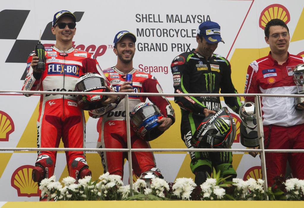 (L-R) Jorge Lorenzo of Spain and Ducati Team, Andrea Dovizioso of Italy and Ducati Team and Johann Zarco of France and Monster Yamaha Tech 3 celebrate on the podium at the end of the MotoGP race during the MotoGP Of Malaysia - Race at Sepang Circuit on October 29, 2017 in Kuala Lumpur, Malaysia. (L-R) Jorge Lorenzo of Spain and Ducati Team, Andrea Dovizioso of Italy and Ducati Team and Johann Zarco of France and Monster Yamaha Tech 3 celebrate on the podium at the end of the MotoGP race during the MotoGP Of Malaysia - Race at Sepang Circuit on October 29, 2017 in Kuala Lumpur, Malaysia.