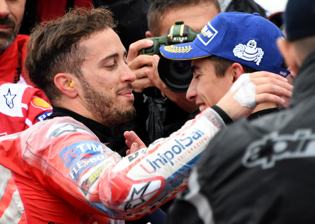 Ducati rider Andrea Dovizioso of Italy (L) is congraturated by Honda rider Marc Marquez of Spain (R) at the parc ferme during the MotoGP Japanese Grand Prix at Twin Ring Motegi circuit in Motegi, Tochigi prefecture on October 15, 2017. Ducati rider Andrea Dovizioso of Italy (L) is congraturated by Honda rider Marc Marquez of Spain (R) at the parc ferme during the MotoGP Japanese Grand Prix at Twin Ring Motegi circuit in Motegi, Tochigi prefecture on October 15, 2017.