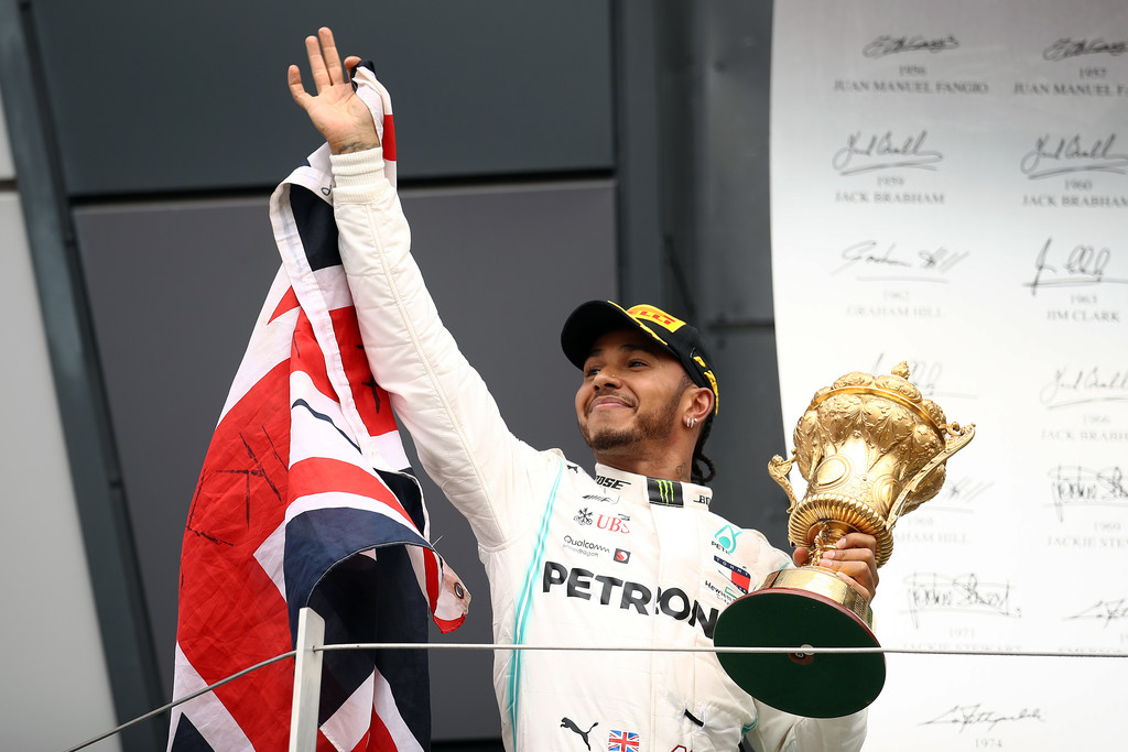 Race winner Lewis Hamilton of Great Britain and Mercedes GP celebrates on the podium during the F1 Grand Prix of Great Britain at Silverstone on July 14, 2019 in Northampton, England. Race winner Lewis Hamilton of Great Britain and Mercedes GP celebrates on the podium during the F1 Grand Prix of Great Britain at Silverstone on July 14, 2019 in Northampton, England.